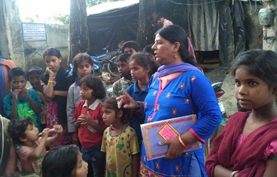 A woman standing among destitute-looking children outside a shack