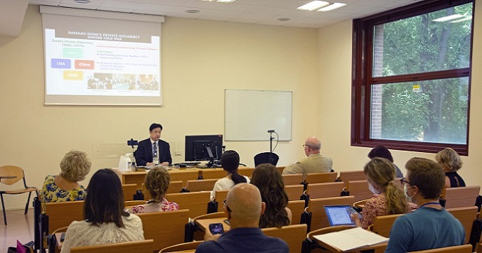 People seated in a conference room listening to a presentation