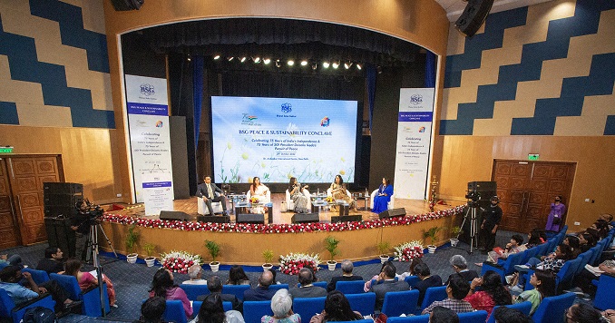 People seated on a stage facing the audience.