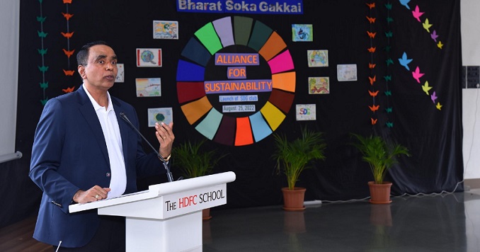 Man behind a white podium next to SDG logo