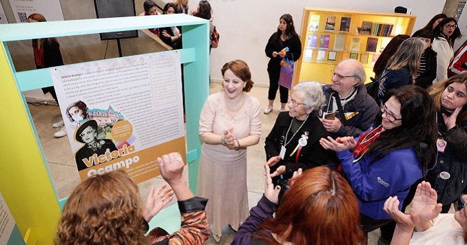 People looking at an exhibition panel.