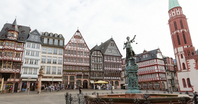 A statue in front of some old buildings