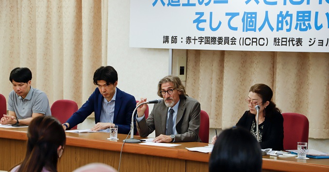 Four people seated facing an audience