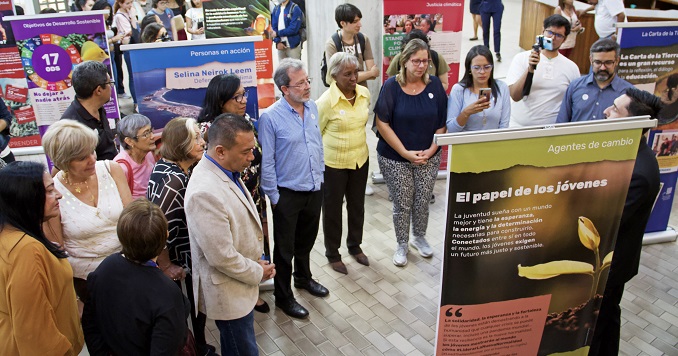 A group of people looking at exhibition panels