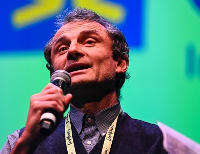 Close up of a man speaking into a microphone