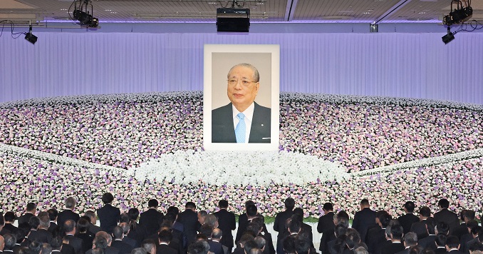Framed photo of a man surrounded by flowers.