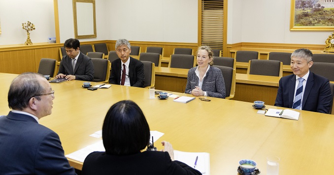 People seated at a conference room table