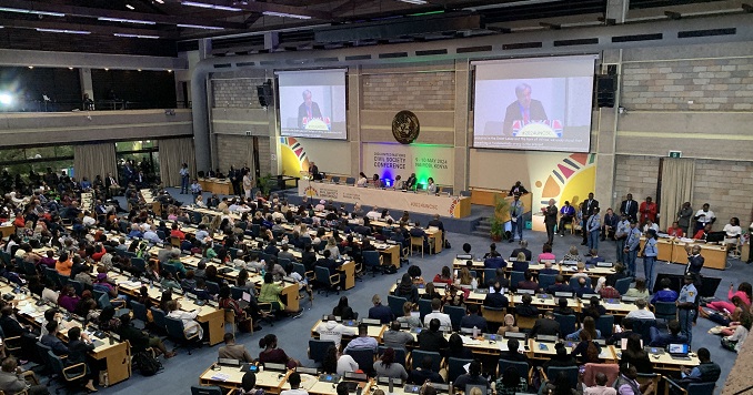 People from around the world gathering in a grand hall.