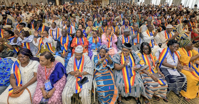 People sitting in a large hall.