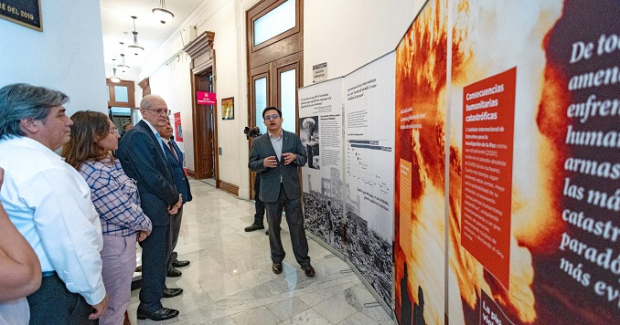 People viewing panels of an exhibition.