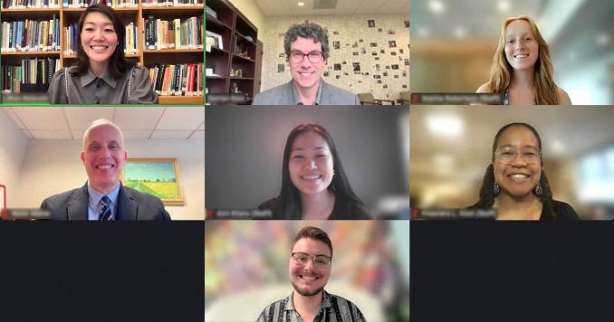 People smiling in an online conference meeting.