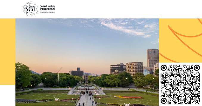 View of Hiroshima Peace Memorial Park, featuring a long pathway leading to the curved cenotaph monument with the Atomic Bomb Dome—an old, partially ruined building in the background.