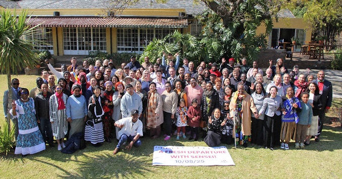 People standing in a garden for a commemorative photo.