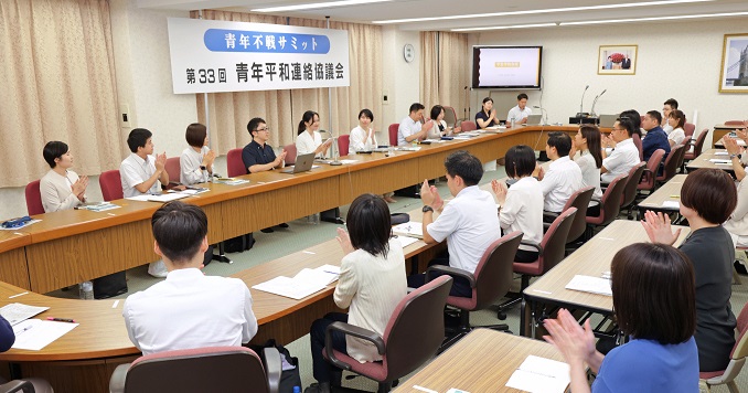Young people sitting in a small conference room listening to panelists speak.
