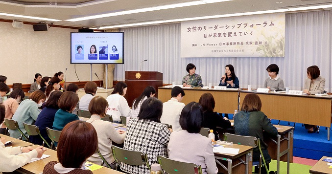 Four seated women facing an audience.