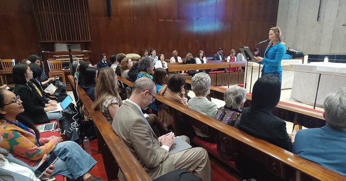 An audience listens to a speaker in the chapel at the Church Center for the United Nations