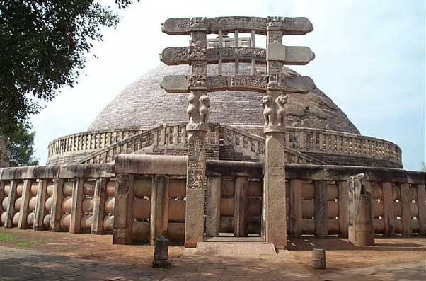 A dome-shaped stone monument with carved gate posts