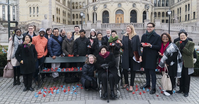 Group of people in front of Norway’s parliament building