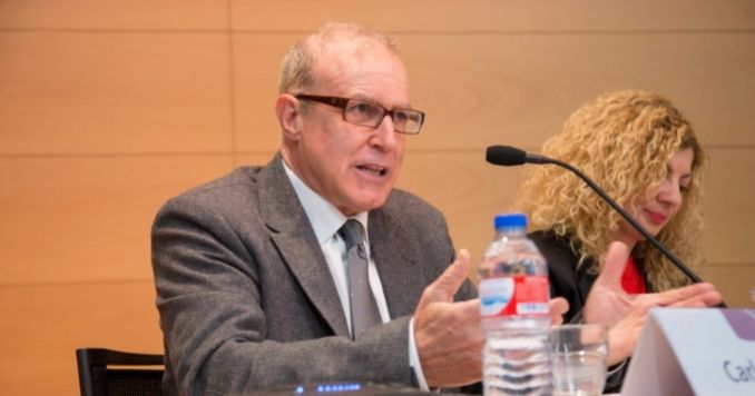 Seated man speaking into a microphone