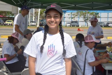 Posed shot of a young woman next to an event tent