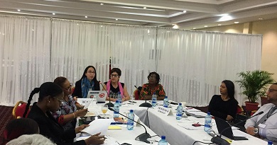 Several people in discussion around a conference table