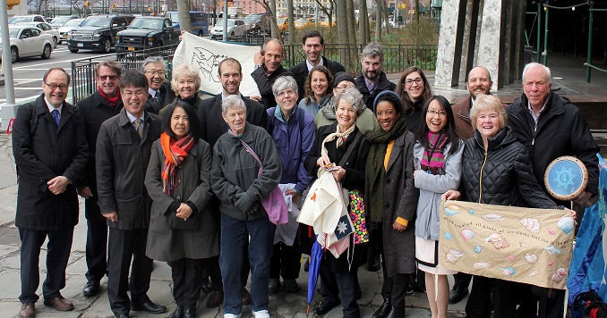 A group photo of around 20 smiling adults