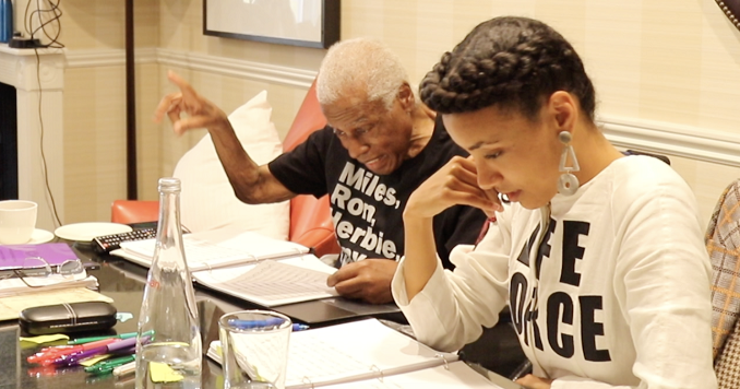 Wayne and Esperanza sitting side by side reviewing a music score