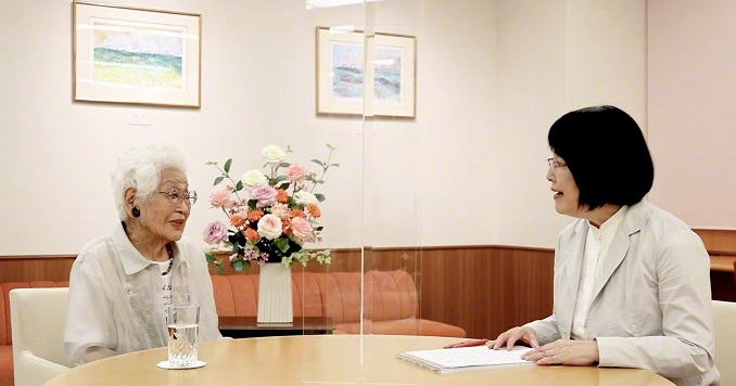 Two women talking at a conference table