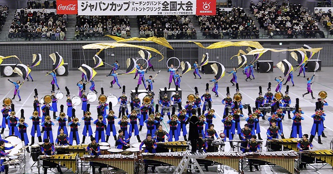 A marching band performing in an auditorium