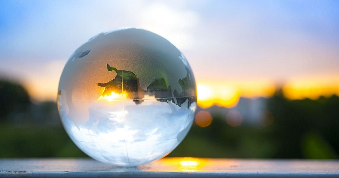 Close-up of a crystal globe against the sky during sunset