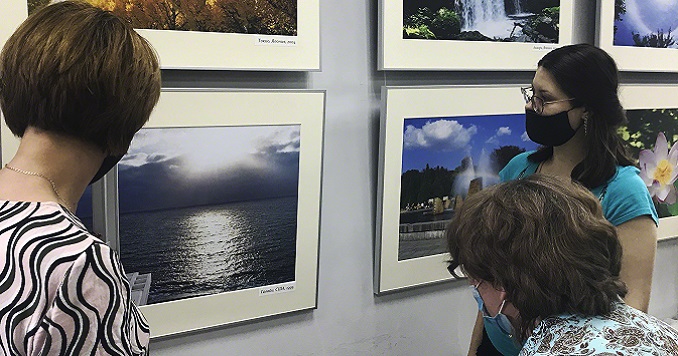 A group of people viewing the mounted photographs