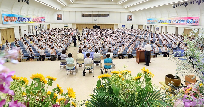 Stage view of a large hall filled with seated people