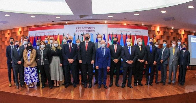 A group of people standing for a photo on a low stage