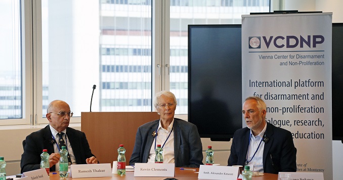 Three men seated at a conference table