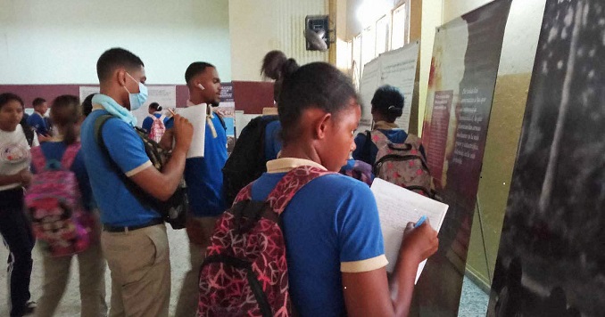 Pupils exploring an exhibition and taking notes