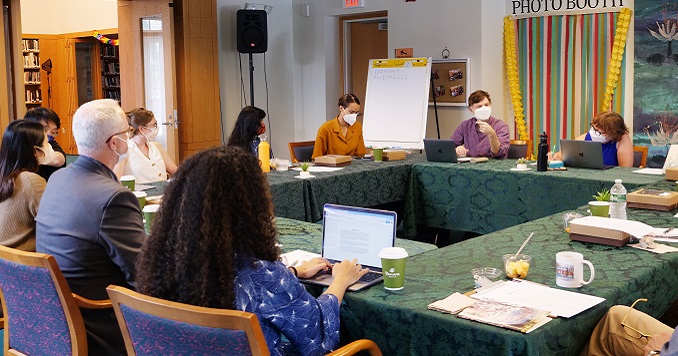 Attendees of a seminar seated around a table