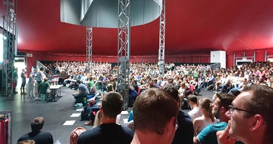 A hall filled with students awaiting speakers to come on stage