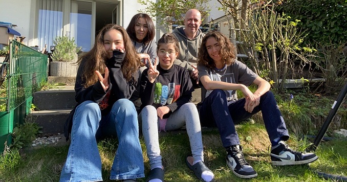 Family sitting on steps outside